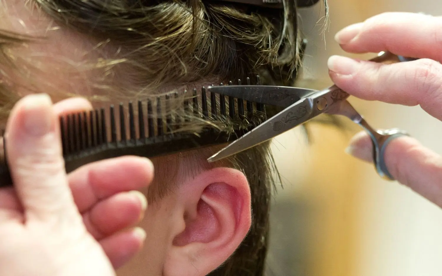 Auch zu Hause sind Friseure verboten. Ein mobiler Friseur darf also auch nicht in die eigene Wohnung kommen und sich dort um die Corona-Frisur kümmern.