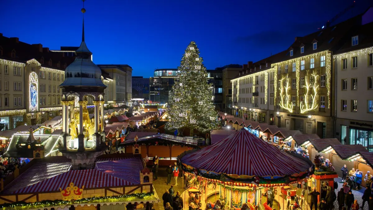 Magdeburger Weihnachtsmarkt und Lichterwelt: ARCHIV - 21.11.2022, Sachsen-Anhalt, Magdeburg: Besucher gehen über den Weihnachtsmarkt der Landeshauptstadt. Beim Personal hadern viele Händler, da es immer schwerer werde, genügend und gutes Personal zu finden. (zu dpa: «Händler hadern mit Personalproblemen bei Weihnachtsmärkten») Foto: Klaus-Dietmar Gabbert/dpa +++ dpa-Bildfunk +++