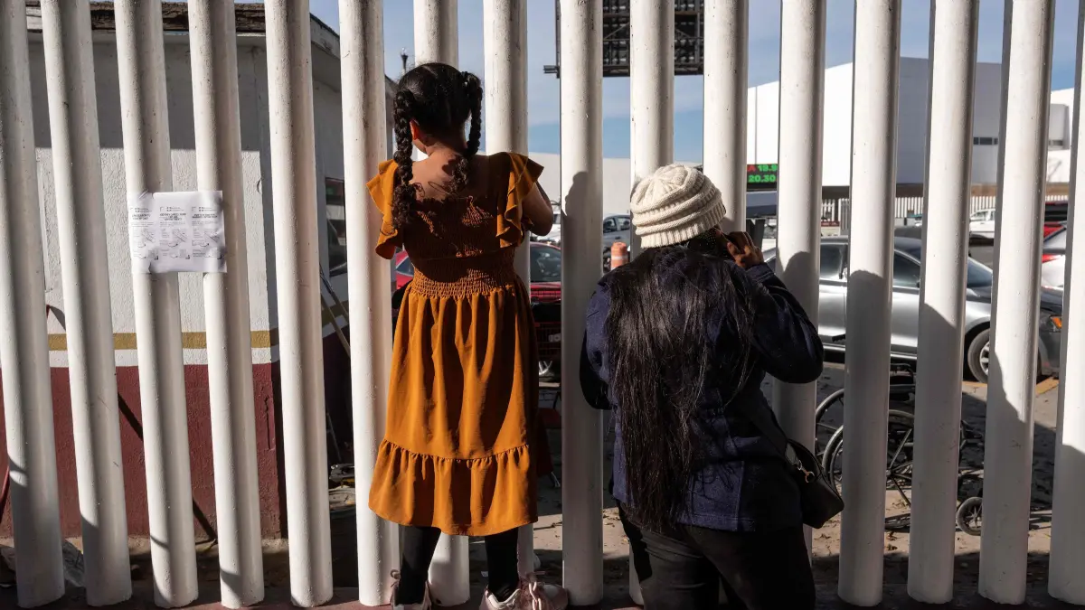 Asylum seekers wait for news on the CBP One appointments at El Chaparral crossing port in Tijuana, Baja California state, Mexico, on January 21, 2025. Mexican President Claudia Sheinbaum called Tuesday for "cool heads" in the face of US President Donald Trump's announcement of severe new restrictions on migration, among other policy changes. Sheinbaum said Mexico was preparing to repatriate people from other countries expelled by the United States, after Trump vowed to deport "millions and millions" of migrants. (Photo by Guillermo Arias / AFP)