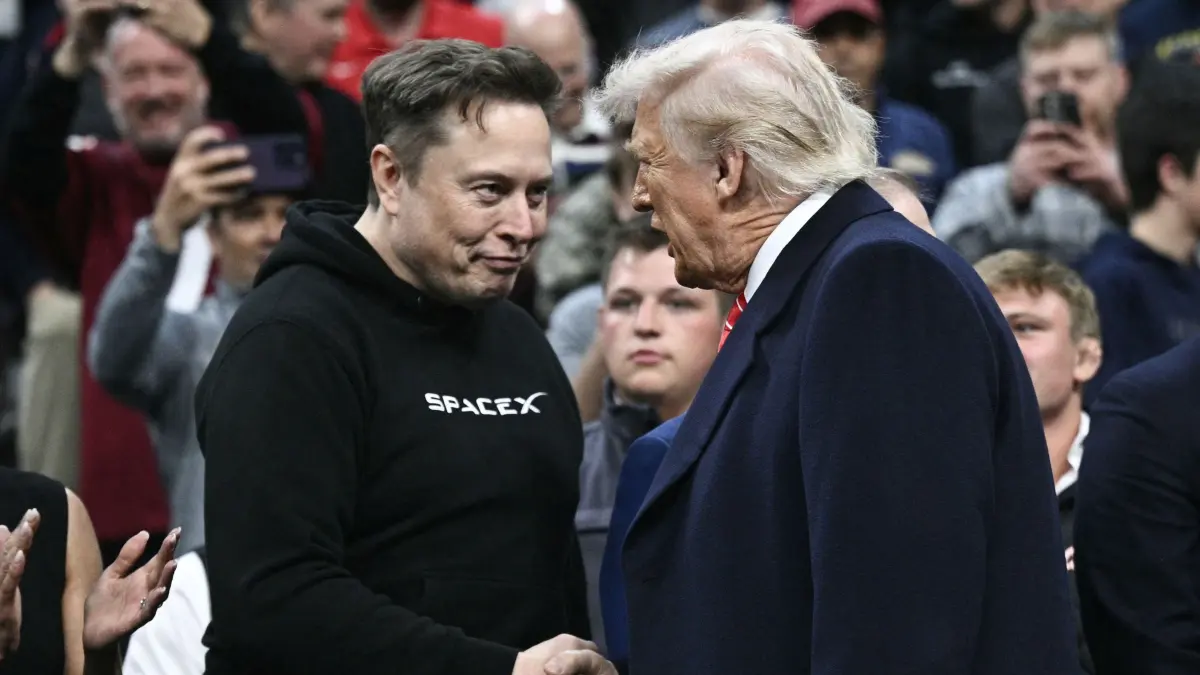 (FILES) Tesla and SPaceX CEO Elon Musk and US President Donald Trump shake hands as they attend the men's NCAA wrestling competition at the Wells Fargo Center in Philadelphia, Pennsylvania, on March 22, 2025. Musk's rise as President Donald Trump's all-powerful wingman was as rapid and unstoppable as one of his SpaceX rockets. But reports April 2, 2025 are fueling speculation that the billionaire's political career may be coming back to Earth. Politico and ABC News quoted unnamed sources saying Musk could step away from an unprecedented role in which he is spearheading brutal cuts to US government services and has emerged only second to Trump as the face of the administration. (Photo by Brendan SMIALOWSKI / AFP) / ALTERNATE CROP