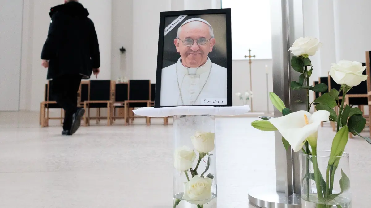 Papst Franziskus gestorben - Berlin: 21.04.2025, Berlin: Ein Bild des verstorbenen Papstes Franziskus steht in der St. Hedwigs-Kathedrale. Das Oberhaupt der römisch-katholischen Kirche starb am Ostermontag im Alter von 88 Jahren. Foto: Carsten Koall/dpa - ACHTUNG: Nur zur redaktionellen Verwendung im Zusammenhang mit der aktuellen Berichterstattung +++ dpa-Bildfunk +++