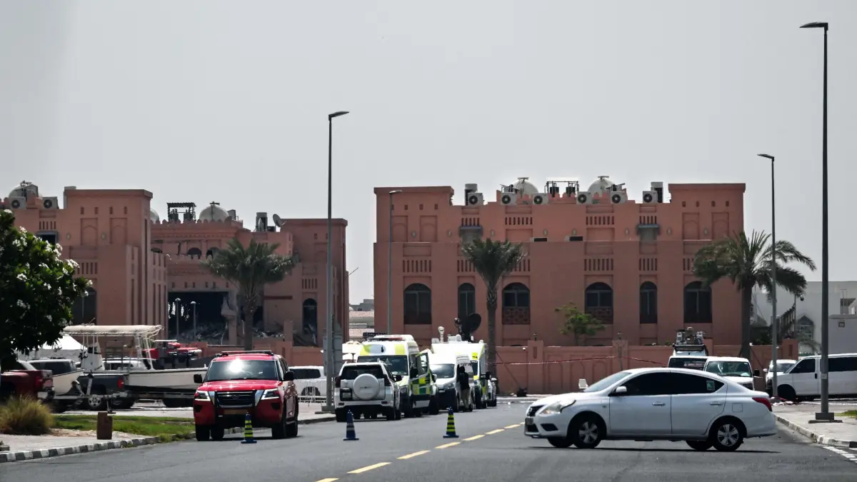 A picture taken from a distance shows the damaged building (L) in the compound housing members of Palestinian militant group Hamas's political bureau which was targeted the previous day by an Israeli strike in Qatar's capital Doha, on September 10, 2025. Qatar denied on September 10 receiving advance warning from the United States of Israeli strikes on Doha, saying the notification came after the attack had already started. (Photo by AFP)