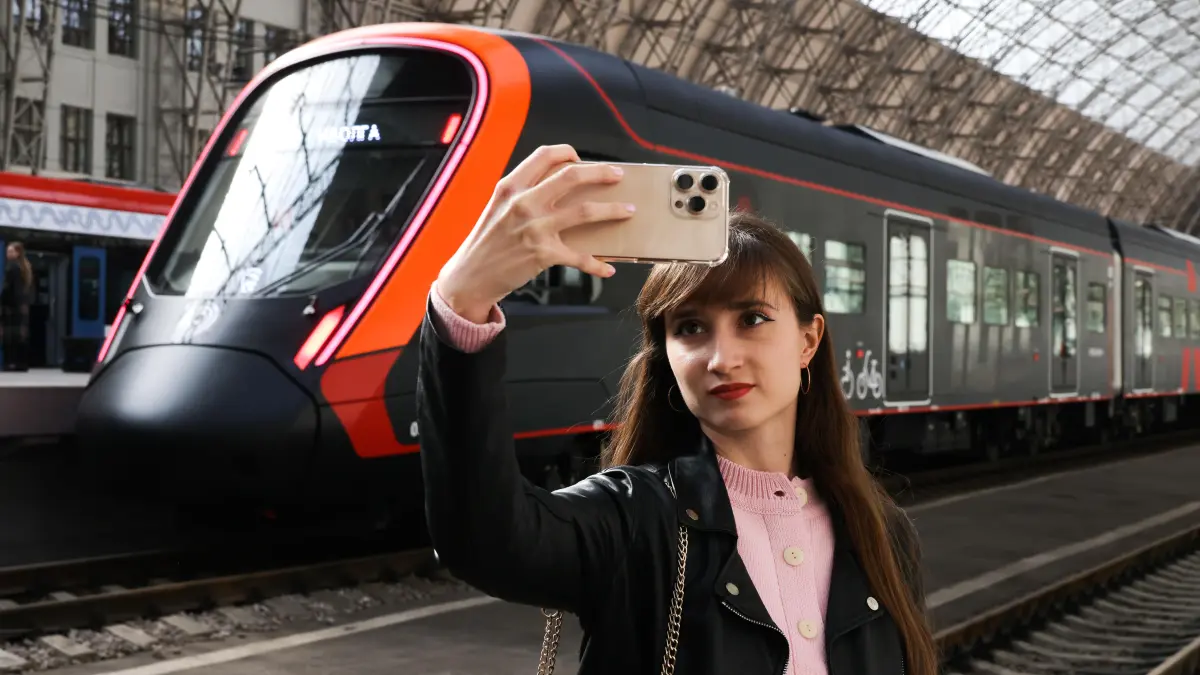 Schwarze Edition: Vorstellung eines neuen Elektrozugs vom Typ Ivolga 4.0 auf dem Kiewer Bahnhof in Moskau: RUSSIA, MOSCOW - OCTOBER 4, 2025: A girl takes a selfie at the launch of a black edition of the Ivolga 4.0 electric train at the Kiyevsky railway station. This is the 100th Ivolga train manufactured by Transmashholding. Sergei Karpukhin/TASS / action press