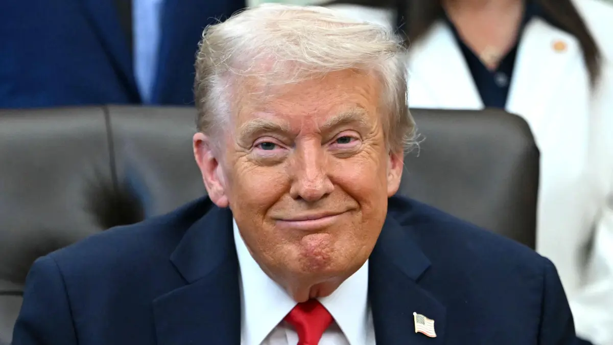 US President Donald Trump smiles during an announcement in the Oval Office of the White House in Washington, DC, on October 16, 2025. (Photo by ANDREW CABALLERO-REYNOLDS / AFP)