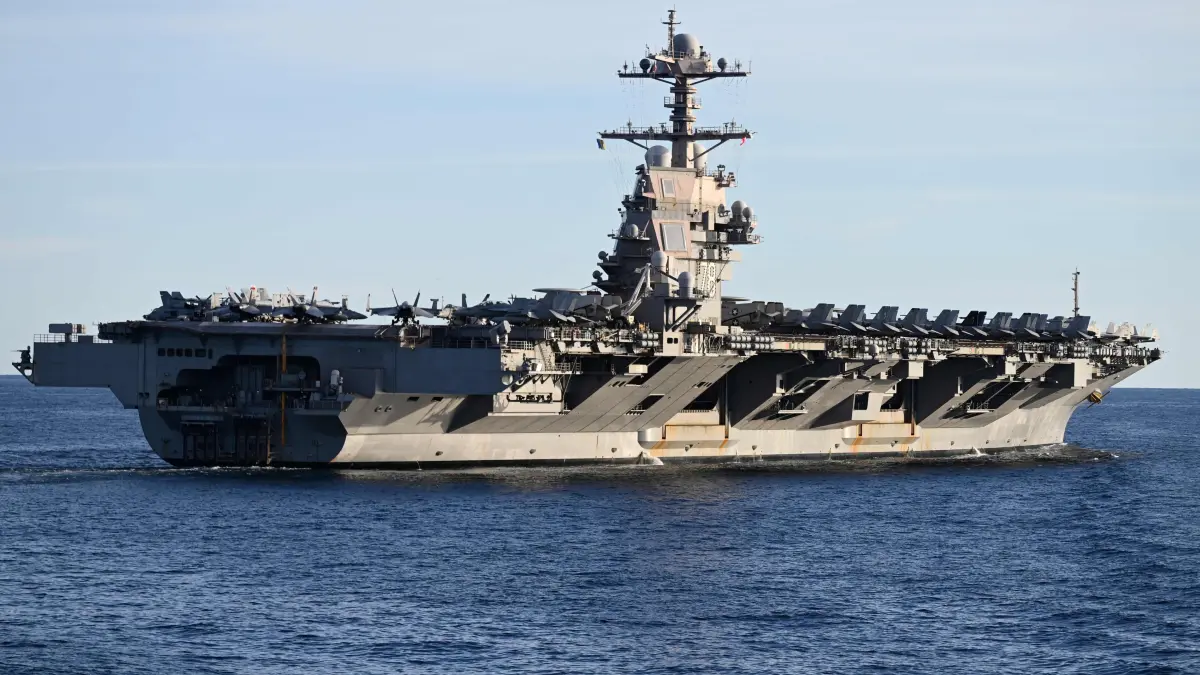 NATO holds military exercises with focus on Baltic: (FILES) The USS Gerald R. Ford, the world's largest aircraft carrier, seen in the North Sea during NATO Neptune Strike 2025 exercise on September 24, 2025 in the North Sea. Washington is deploying an aircraft carrier and accompanying ships to counter drug-trafficking organizations in Latin America, the Pentagon said on October 24, 2025, marking a massive increase in US firepower in the region. The deployment of the USS Gerald R. Ford carrier strike group is "in support of the president's directive to dismantle Transnational Criminal Organizations (TCOs) and counter narco-terrorism in defense of the Homeland," Pentagon spokesman Sean Parnell said in a post on X. (Photo by Jonathan KLEIN / AFP)
