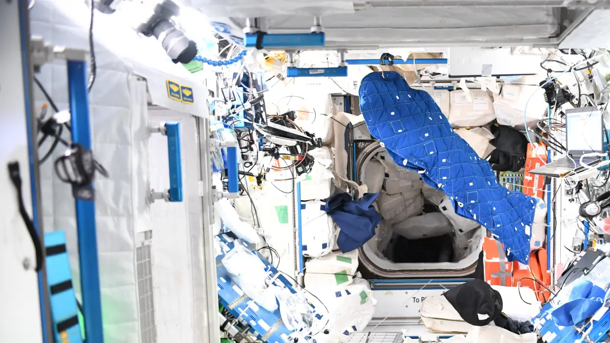 NASA-Astronautin Kayla Barron öffnet die Luke zum Columbus-Modul der ESA wieder, nachdem die seitlichen Module der Raumstation zwei Tage und Nächte lang aus Vorsichtsgründen vor Weltraumschrott geschlossen gewesen waren.