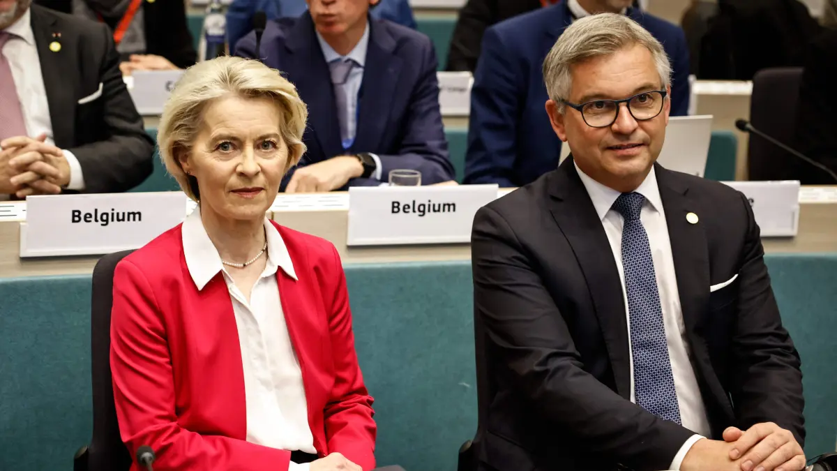 European Commission President Ursula von der Leyen (L) sits next to EU Commissioner for Internal Affairs and Migration Magnus Brunner (R) during the 2025 International Conference of the Global Alliance to Counter Migrant Smuggling at the European Commission In Brussels, on December 10, 2025. (Photo by Simon Wohlfahrt / AFP)
