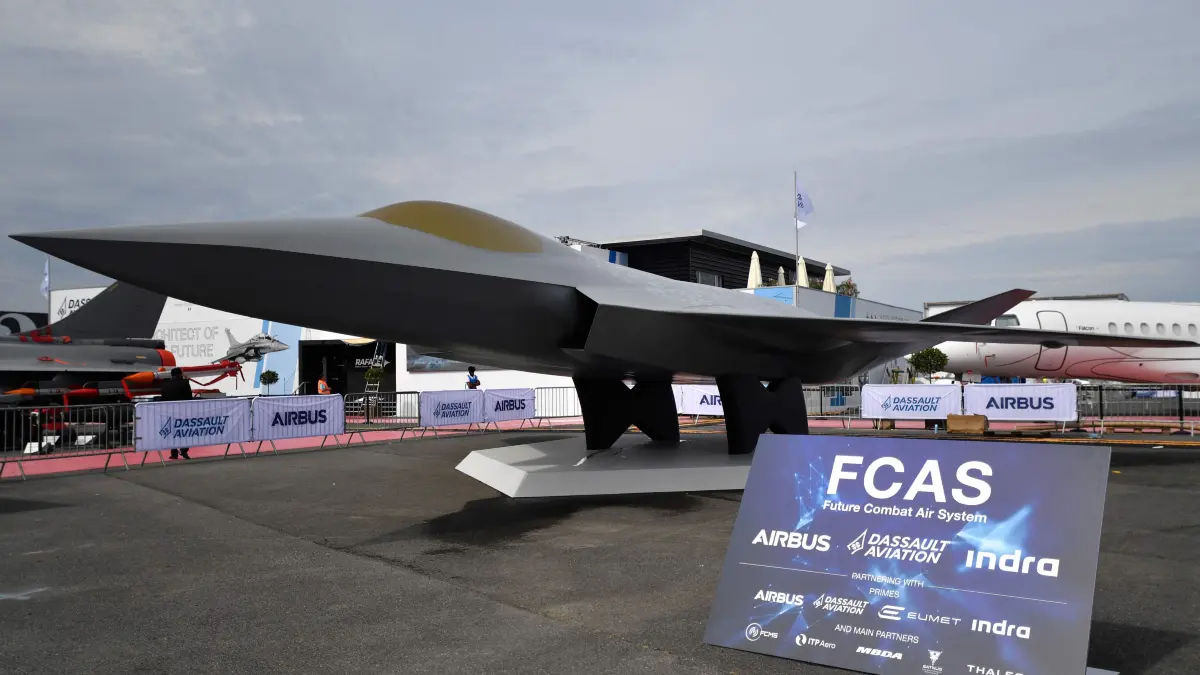 (FILES) This photograph taken on June 18, 2023 shows a mock-up of the European New Generation Fighter (NGF) for the Future Combat Air System (FCAS) under development by Dassault Aviation, Airbus and Indra Sistemas during the International Paris Air Show at the Paris–Le Bourget Airport. Germany does not need the same fighter jets as France, German Chancellor Friedrich Merz said in an interview broadcast on February 18, 2026, signalling that Berlin could abandon a flagship joint defence project. "The French need, in the next generation of fighter jets, an aircraft capable of carrying nuclear weapons and operating from an aircraft carrier. That's not what we currently need in the German military," Merz said on the German podcast Machtwechsel. The Future Combat Aircraft System (FCAS) programme was launched in 2017 to replace France's Rafale jet and the Eurofighter planes used by Germany and Spain by 2040. (Photo by JULIEN DE ROSA / AFP)