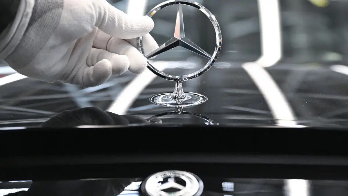 Mercedes-Benz: ARCHIV - 30.04.2026, Baden-Württemberg, Sindelfingen: Ein Mercedes-Benz Arbeiter montiert im Mercedes-Benz Werk Sindelfingen in der Factory 56 einen Mercedes-Stern auf ein Fahrzeug der S-Klasse. (zu dpa «Mercedes-Benz verkauft Autohäuser in Berlin und Brandenburg») Foto: Bernd Weißbrod/dpa +++ dpa-Bildfunk +++