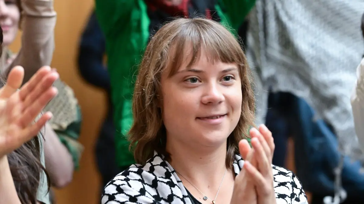 22.05.2026, Baden-Württemberg, Stuttgart: Die Klimaaktivistin Greta Thunberg klatscht als Zuschauerin in einem Gerichtssaal in Stuttgart-Stammheim bei einem Prozess um einen Anschlag gegen ein israelisches Rüstungsunternehmen in Richtung der Angeklagten. Fünf Pro-Palästina-Aktivisten stehen vor Gericht. Sie brachen der Anklage zufolge nachts in ein israelisches Rüstungsunternehmen in Ulm ein, zerstörten Inventar, sprühten die Wände voll und verursachten einen Millionenschaden. (zu dpa: «Nach Angriff auf Rüstungsfirma - Angeklagter kommt zu Wort») Foto: Bernd Weißbrod/dpa +++ dpa-Bildfunk +++