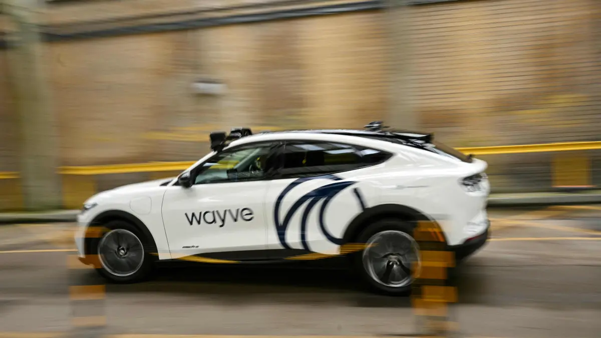 A car from British autonomous driving technology company Wayve Technologies Ltd is pictured driving around the street, on the sidelines of London Tech Week in London on June 8, 2026. In London, three groups of autonomous vehicles will launch trials this year: robotaxi world leader Waymo, a subsidiary of Google parent Alphabet; its competitor Wayve, in partnership with Uber; and the Chinese company Apollo Go, a subsidiary of the tech giant Baidu. (Photo by Ben STANSALL / AFP)