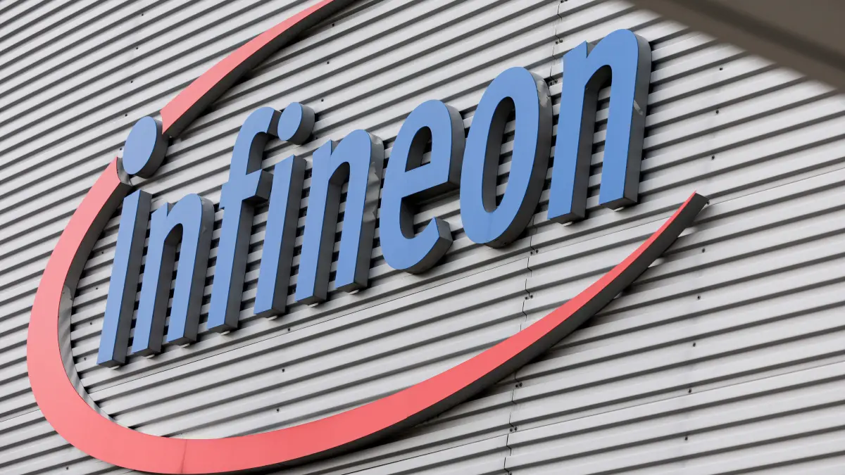 The logo of German semiconductor manufacturer Infineon Technologies AG is seen at the company's plant in Dresden, eastern Germany, on June 10, 2026. On July 2, 2026, Infineon will officially open its Smart Power Fab that manufactures
power semiconductors as well as analog/mixed-signal-components in Dresden. With an investment of five billion euros, the new facility represents the largest single investment in Infineon's history. (Photo by Jens SCHLÜTER / AFP)