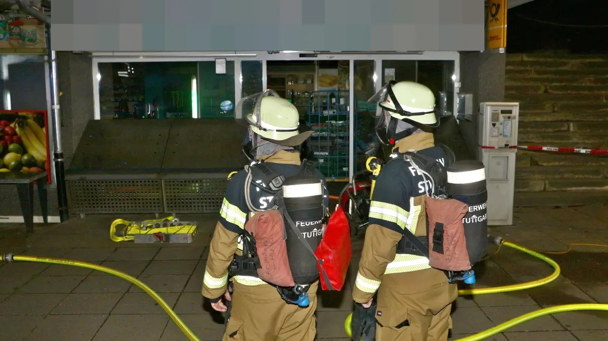 06.07.2026: Am frühen Montagmorgen brach in einem Supermarkt in Stuttgart-Giebel ein Brand aus. Nach Angaben der Feuerwehr auf X drang beim Eintreffen der ersten Kräfte aus den Räumen eines türkischen Supermarkts an der Giebelstraße. Umgehend wurde ein Rohr zur Brandbekämpfung über die Eingangstür vorgenommen, parallel dazu wurden die über dem Markt liegenden Wohnungen geräumt. Laut der Feuerwehr brannte ein Elektrogerät, das Feuer hatte bereits auf ein Regal übergegriffen. Während mit der Drehleiter die Wohnungen von außen kontrolliert wurden, kamen zwei Hochleistungslüfter zum Einsatz um das Ladenlokal zu entrauchen. Nach Angaben der Feuerwehr gab es keine Verletzten, die Giebelstraße musste während der Einsatzmaßnahmen voll gesperrt werden.
Foto: KS-Images.de/Andreas Rometsch
