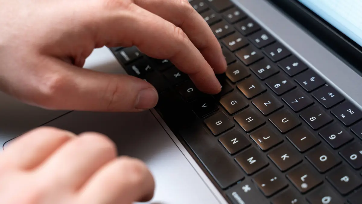 Bavaria, Germany - November 24, 2023: Man operating the keyboard of a laptop computer with his hands. Writing on the computer keyboard *** Mann bedient mit den Händen die Tastatur von einem Laptop Computer. Schreiben an der Computertastatur
