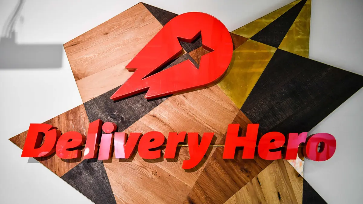 FILES-GERMANY-US-MERGER-FOOD-DELIVERYHERO-UBER: (FILES) A view of a logo in a lounge area of the global headquarters of online food ordering and delivery giant Delivery Hero is pictured in Berlin on June 27, 2017. German food delivery group Delivery Hero said on July 16, 2026 it has agreed to be taken over by US ride-hailing giant Uber in a 12.7-billion-euro ($14.6-billion) deal. (Photo by John MACDOUGALL / AFP)