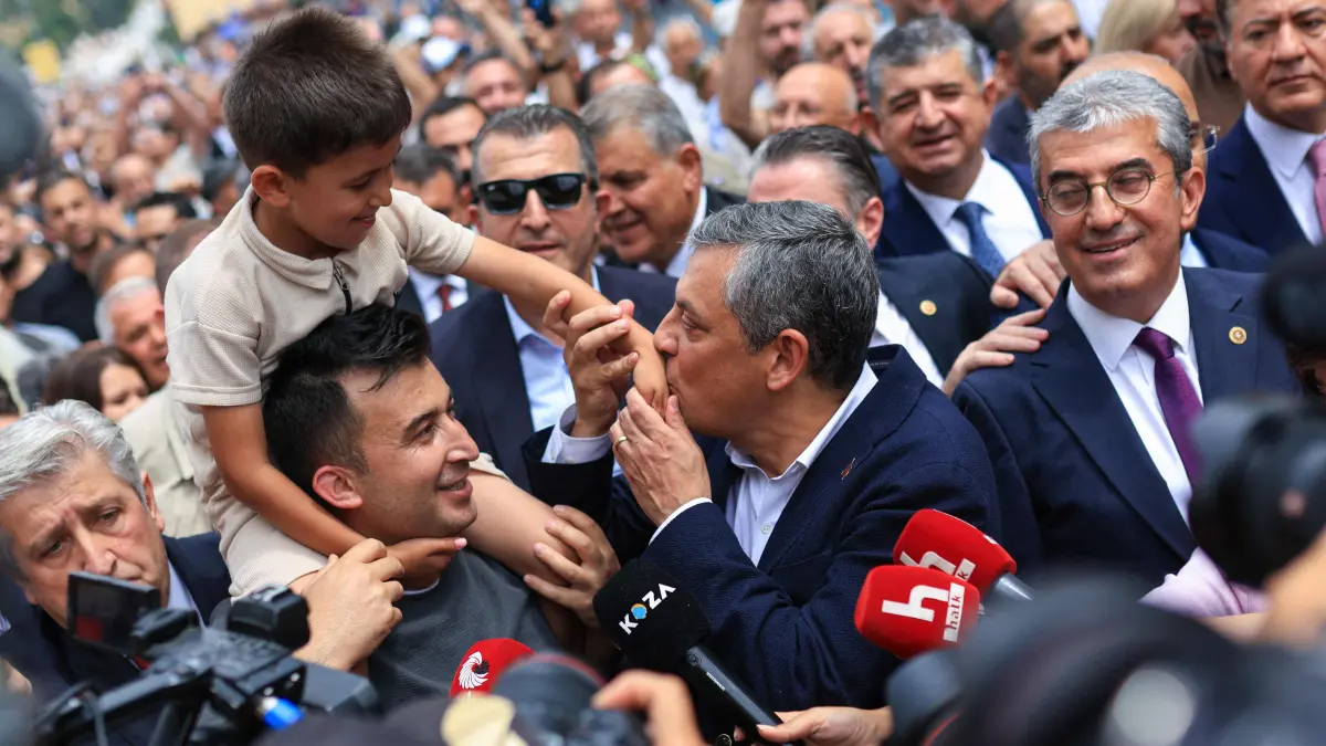 Ousted Turkey opposition leader Ozgur Ozel quits CHP to form new party: This handout photograph taken and released by the Yeni Party (New Party) press office on July 24, 2026, shows the leader of the Yeni Party (New Party) Ozgür Ozel greeting his supporters after a friday praying at Haci Bayram mosque in Ankara. Ousted as leader of Turkey's main opposition party CHP, Ozgur Ozel on July 24, 2026 said he was resigning to set up his own opposition faction from which to lead the fight against President Recep Tayyip Erdogan. Ozel signed his resignation papers and also signed the founding documents for the "Yeni Parti" ("New Party"), saying another 91 CHP lawmakers had also resigned and would be joining him. (Photo by Handout / AFP) / RESTRICTED TO EDITORIAL USE - MANDATORY CREDIT "AFP PHOTO / YENI PARTY PRESS OFFICE/ HANDOUT / " - NO MARKETING NO ADVERTISING CAMPAIGNS - DISTRIBUTED AS A SERVICE TO CLIENTS