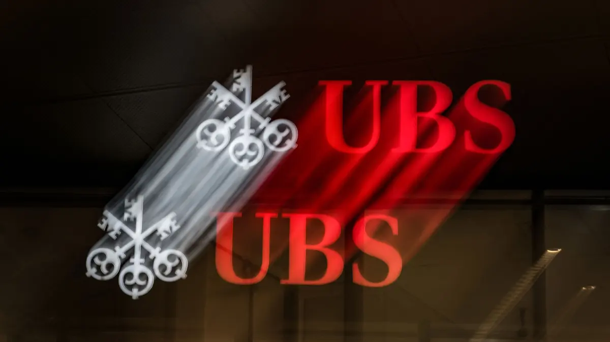 FILES-SWITZERLAND-BANKING-EARNINGS-RESULTS: (FILES) This slow shutter speed photograph taken on October 6, 2023, shows a logo sign of Swiss banking giant UBS on a building in Lugano, southern Switzerland. Swiss banking giant UBS reported on July 29, 2026 that net profit rose 17 percent to $2.8 billion in the second quarter, driven by its investment banking arm. (Photo by Fabrice COFFRINI / AFP)