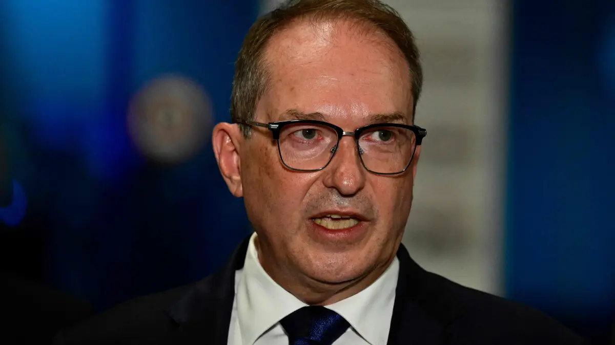 GERMANY-AIRPORT-AVIATION-POLICE: German Interior Minister Alexander Dobrindt addresses a press conference at the German airport Leipzig-Halle in Schkeuditz, eastern Germany, after an explosives-laden drone was found near a Ukrainian cargo plane. German police deployed a bomb disposal robot at the airport after a drone was found near a Ukrainian-flagged cargo plane overnight, also forcing the diversion of numerous flights. Another aircraft, which had to abort its scheduled landing at Leipzig-Halle airport, then collided mid-air with an unknown object several kilometres away but later landed safely, the government said. The airport in eastern Germany plays a key role in the transport of military goods, including by the German military and NATO allies, and also serves as a base for Ukraine's Antonov Airlines (Photo by John MACDOUGALL / AFP)