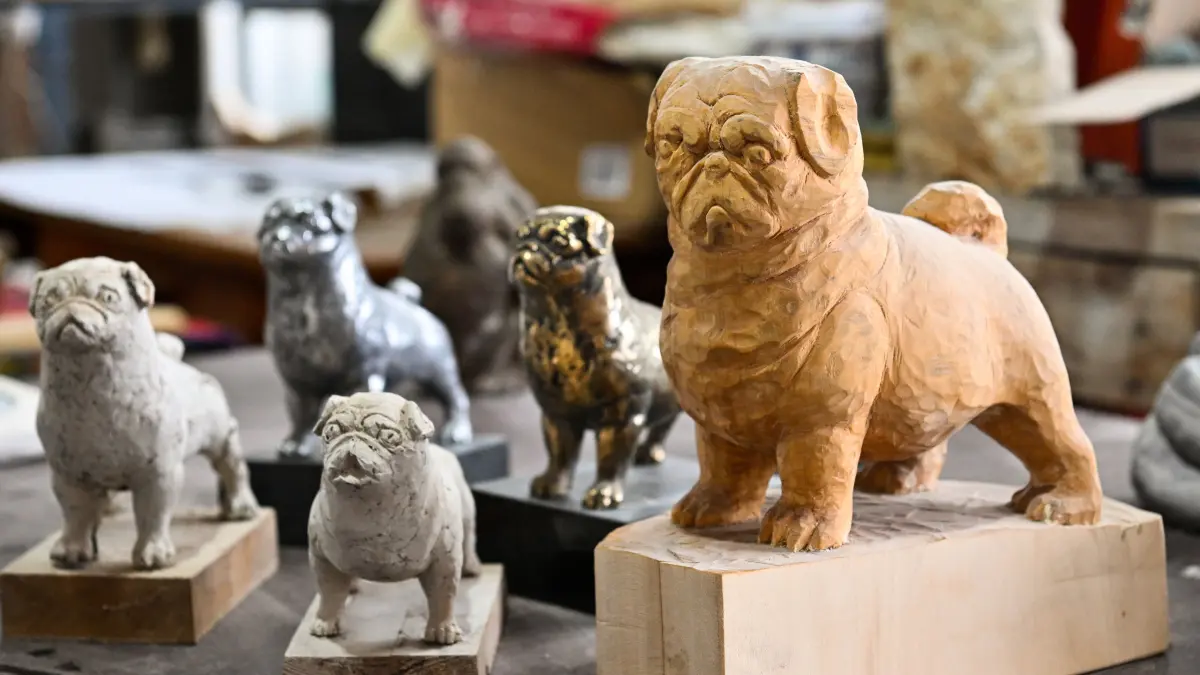 Künstler / Bildhauer Uli Gsell in seinem Atelier in Kemnat mit verschiedenen Mops-Skulpturen