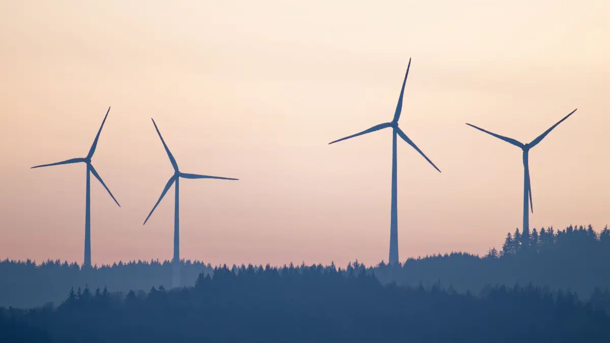 Windkraftanlagen: ARCHIV - 16.12.2025, Baden-Württemberg, Altenbach: Windräder stehen im Licht der aufgehenden Sonne auf einem Hügel des Odenwalds. (zu dpa: «Kabel von Windpark beschädigt - Inbetriebnahme verzögert») Foto: Uwe Anspach/dpa +++ dpa-Bildfunk +++