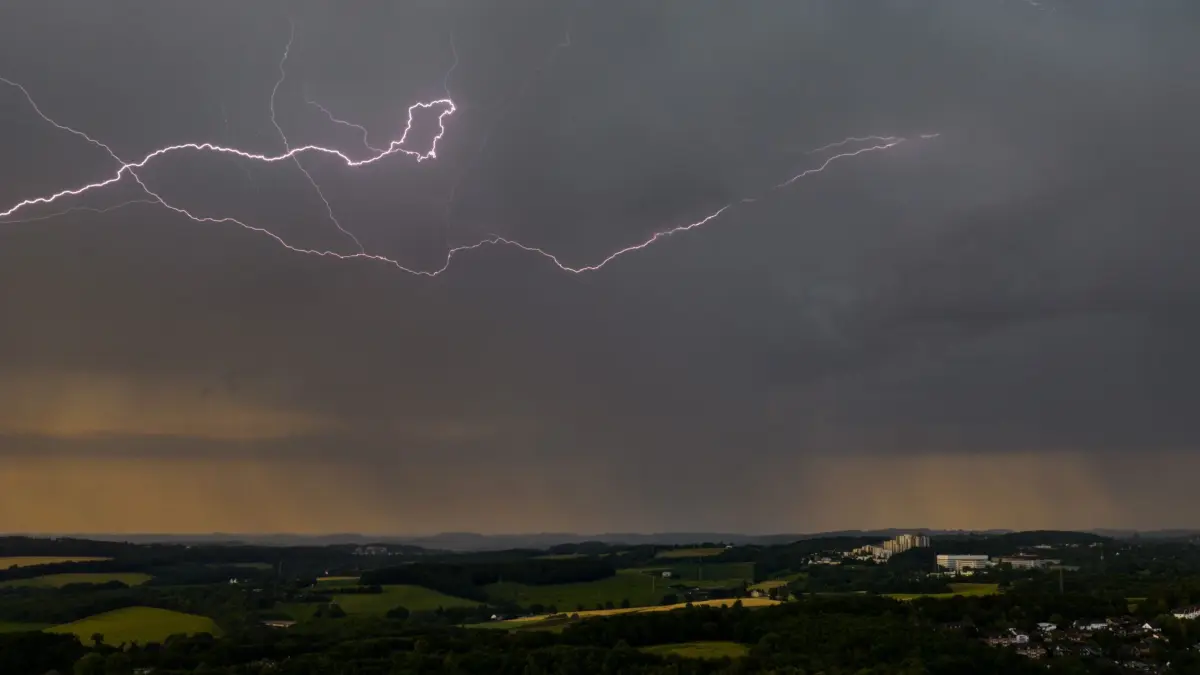 Wetter in NRW: ARCHIV - 19.06.2026, Nordrhein-Westfalen, Wuppertal: Blitze leuchten am Himmel über Wuppertal (Aufnahme mit einer Drohne). (zu dpa: «Gewitter und Starkregen am Wochenende») Foto: Christoph Reichwein/dpa +++ dpa-Bildfunk +++