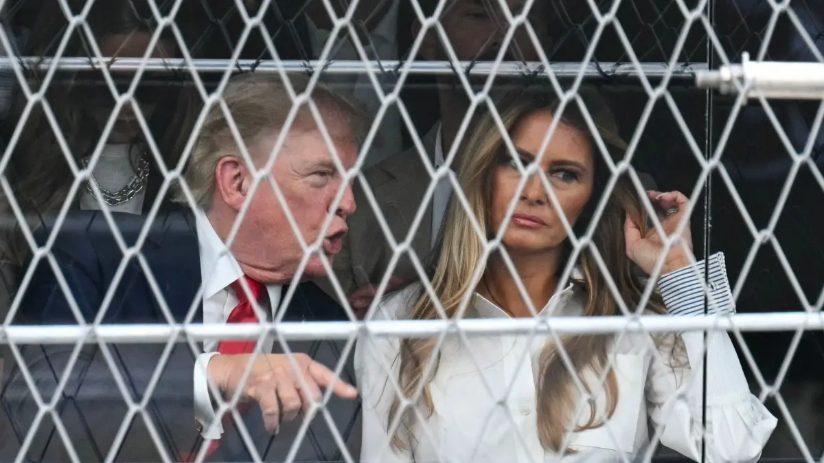 US President Donald Trump attends the Freedom 250 Grand Prix: US President Donald Trump speaks with First Lady Melania Trump as they attend the IndyCar Freedom 250 Grand Prix in Washington, , on August 23, 2026. The Freedom 250 Grand Prix is part of celebrations marking the 250th anniversary of US independence. The race will cover 147 laps of a 1.7-mile, seven-turn street circuit around the National Mall, passing landmarks including the US Capitol and Washington Monument. (Photo by SAUL LOEB / AFP)