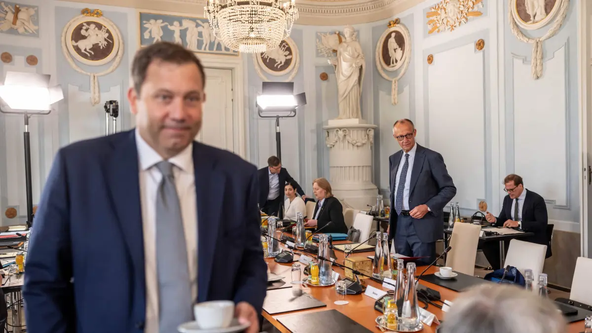 GERMANY-POLITICS-GOVERNMENT-CABINET: German Chancellor Friedrich Merz (background, 2nd R) and German Finance Minister and Vice Chancellor Lars Klingbeil (L) arrive for the start of the second day of a two day retreat meeting of the German cabinet on August 26, 2026 in Neuhardenberg, northeastern Germany. (Photo by Michael Kappeler / POOL / AFP)