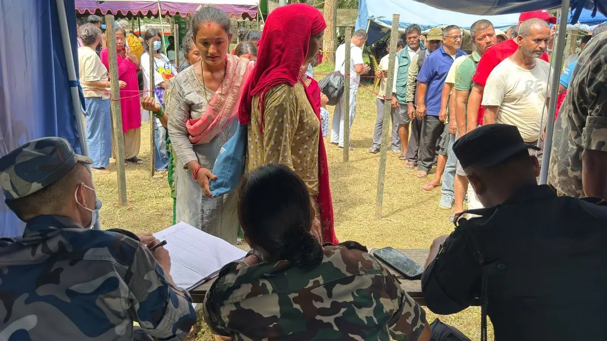 Zahlreiche Personen, die aus einem durch die Sturzflut abgeschnittenen Gebiet gerettet wurden, stehen in einem Armeelager im nepalesischen Distrikt Nuwakot Schlange, um sich registrieren zu lassen.