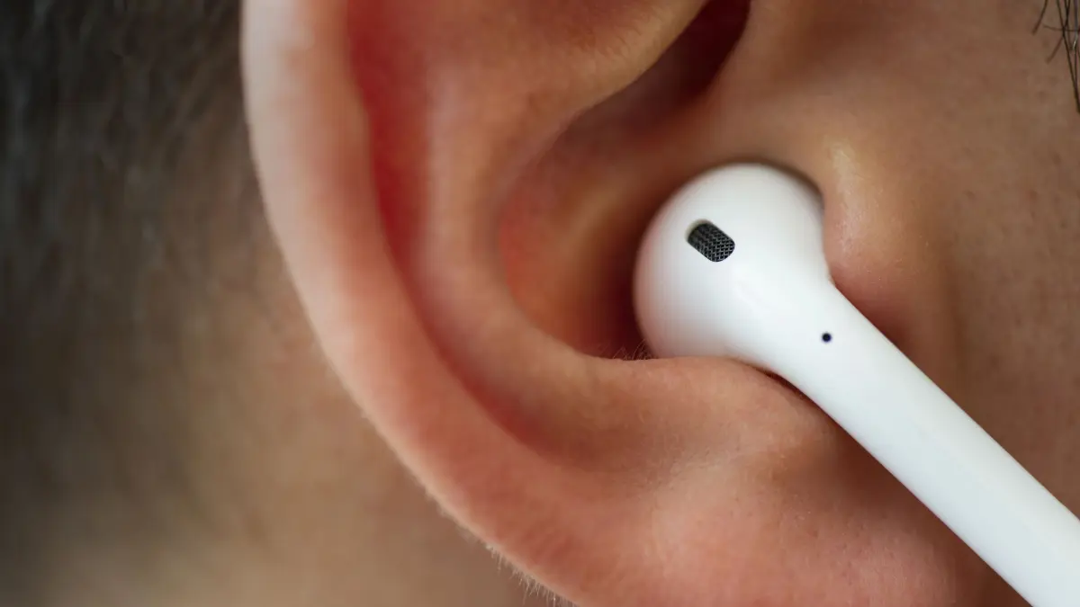 Izmir, Turkey - July 12, 2019: Close up shot of the one of Apple brand airpods on a caucasian white males ear.