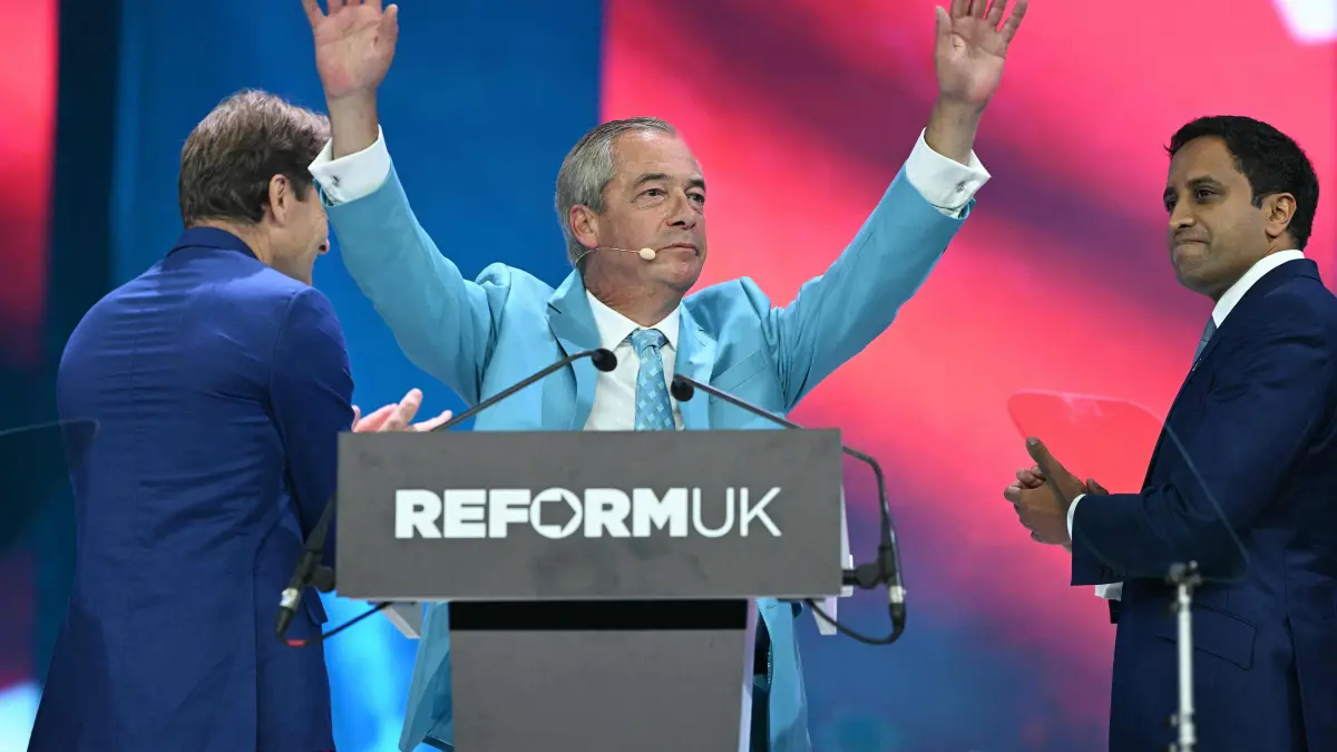 776557546: Reform UK Leader Nigel Farage (C), flanked by Reform UK Deputy Leader Richard Tice (L) and Reform UK's shadow Home Secretary Zia Yusuf, acknowledges the applause at the end of his address on the third day of the annual Reform UK party conference at the NEC in Birmingham, central England on September 5, 2026. (Photo by Oli SCARFF / AFP)