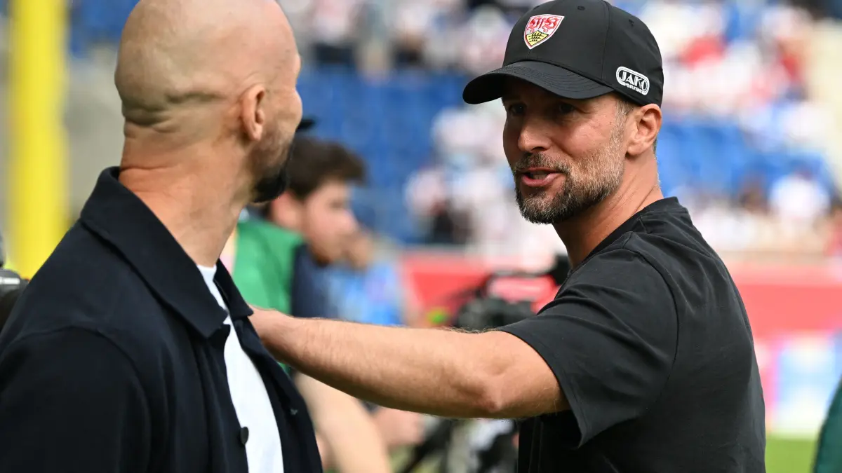 FBL-GER-BUNDESLIGA-HOFFENHEIM-STUTTGART: Hoffenheim's Austrian head coach Christian Ilzer (L) talks to Stuttgart's German head coach Sebastian Hoeness ahead the German first division Bundesliga football match between Hoffenheim and VfB Stuttgart in Sinsheim on September 12, 2026. (Photo by THOMAS KIENZLE / AFP) / DFL REGULATIONS PROHIBIT ANY USE OF PHOTOGRAPHS AS IMAGE SEQUENCES AND/OR QUASI-VIDEO