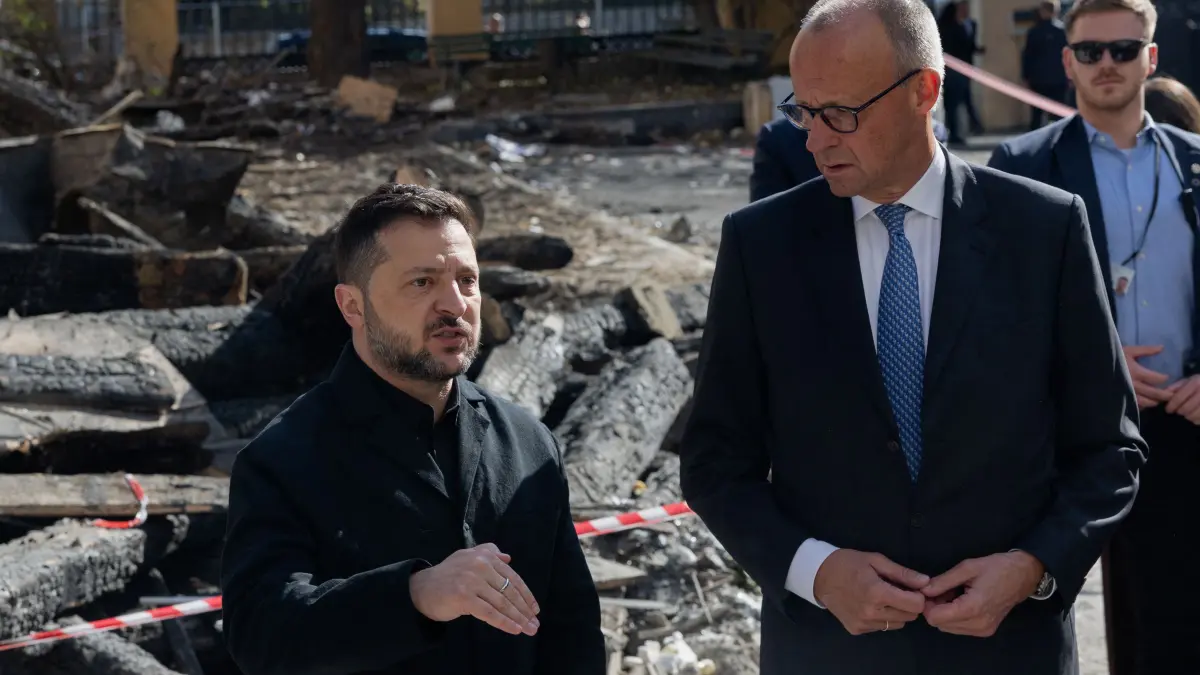 UKRAINE-RUSSIA-CONFLICT-WAR: Ukraine's President Volodymyr Zelensky (L) and German Chancellor Friedrich Merz (R) visit damaged building of the Ukrainian Academy of Science in Kyiv on October 4, 2026, amid the Russian invasion of Ukraine. Germany's chancellor arrived in Ukraine's capital on a surprise visit to demonstrate European support in the face of an upsurge in attacks. (Photo by Tetiana DZHAFAROVA / AFP)