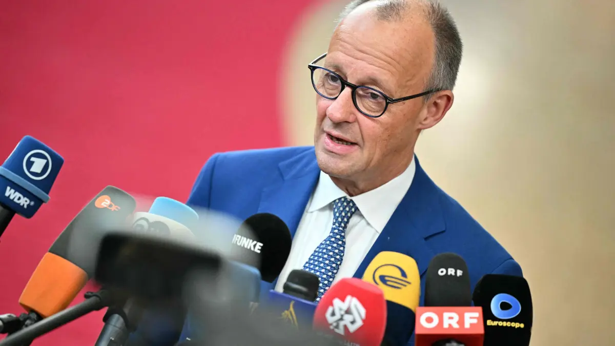 BELGIUM-EU-DIPLOMACY: Germany's Chancellor Friedrich Merz answers journalists' questions upon his arrival for a European Union summit at the EU headquarters in Brussels on October 15, 2026. EU leaders head on October 15, 2026 for their biggest clash yet over the bloc's next long-term budget, as they race to lock in a deal before next year's French presidential election. (Photo by NICOLAS TUCAT / AFP)