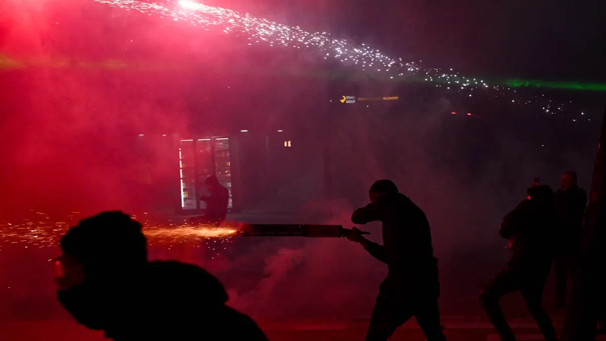 ALBANIA-POLITICS-EDUCATION-DEMO: Protesters use fireworks as they clash with riot police during a national anti-government demonstration - called by the student-led protest movement to demand better support for education and prime minister's resignation, in central Tirana on October 24, 2026. (Photo by Armend NIMANI / AFP)