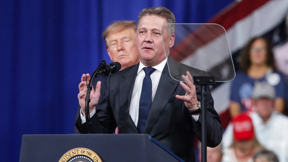 President Trump Holds Rally For Georgia Republican Candidates In Perry, Georgia: PERRY, GEORGIA - OCTOBER 24: Audi AG CEO Gernot Dollner speaks alongside U.S. President Donald Trump during a midterm campaign rally at the Guardian Centers on October 24, 2026 in Perry, Georgia. Trump is speaking at a rally in support of Georgia Republican Senate candidate, Rep. Mike Collins (R-GA), who is trying to unseat the incumbent U.S. Sen. Jon Ossoff (D-GA), and Georgia Republican gubernatorial candidate Rick Jackson. Alex Wong/Getty Images/AFP (Photo by ALEX WONG / GETTY IMAGES NORTH AMERICA / Getty Images via AFP)